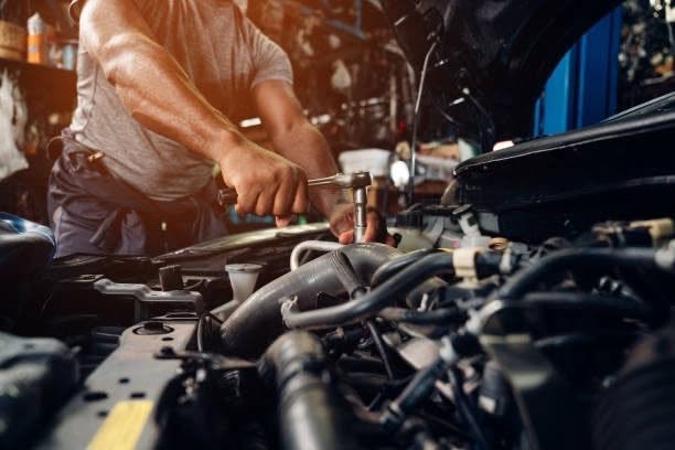Mechanic carrying out servicing work in an engine bay